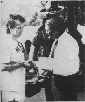 Alan Morris presents a copy of his single 'River Town,' a song celebrating the bicentennial of West Point, Ky., to Kentucky Gov. Wallace Wilkinson. Wilkinson was in West Point following the River City Days Celebration to present a grant to the city. Photo by Eddie Moore