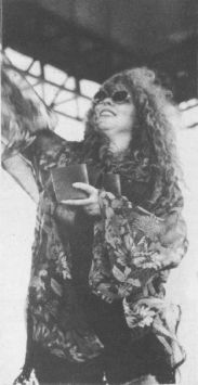 Susan Marshall of the Mother Station tossed free can coolers to the audience during Foxstock '94, held on Oct. 15 at Louisville Motor Speedway