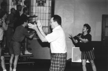 Betty Lou Coleman, right, choreographer with the Sweet Adelines, offers tips to the singers while Buckner directs.